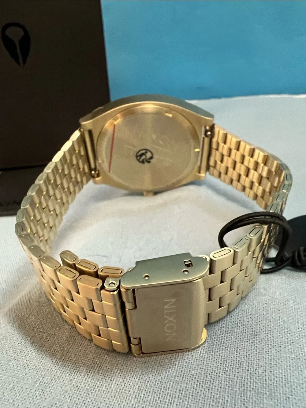 Nixon Gold Watch with Black Dial and Red Accents, Time Teller Model